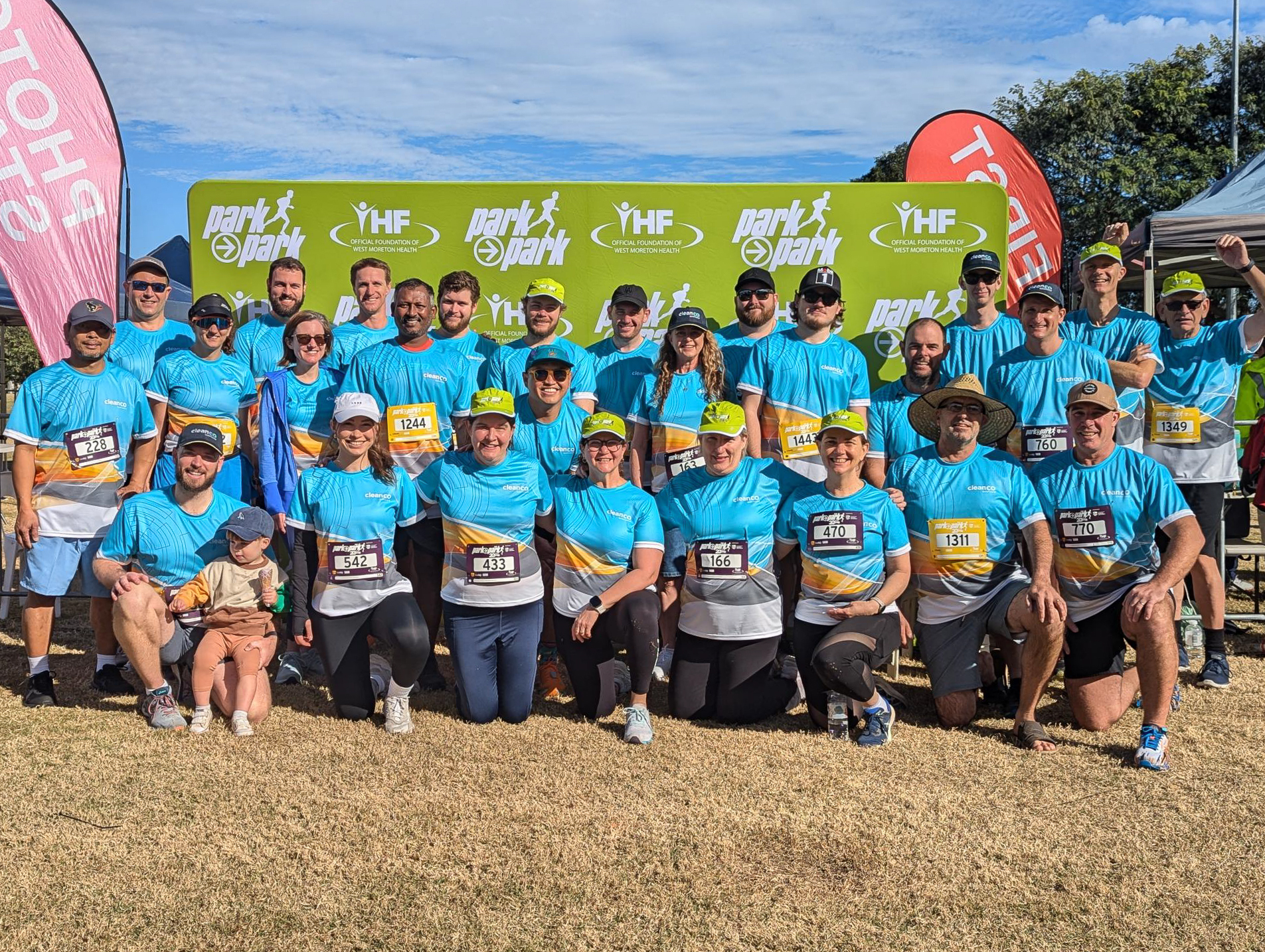 A large group of CleanCo employees wearing CleanCo branded sports shirts