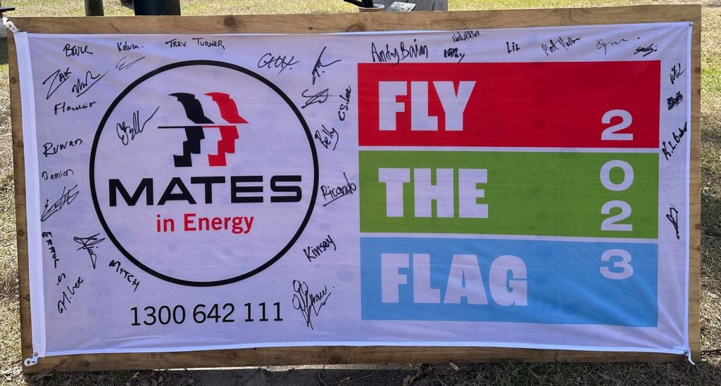 A photo of a Mates in Energy flag signed by staff at CleanCo's Swanbank Power Station.