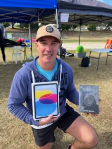 A CleanCo employee holds an ipad he won as a participant in Park2Park