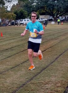 A CleanCo employee running in Park2Park smiles at the camera