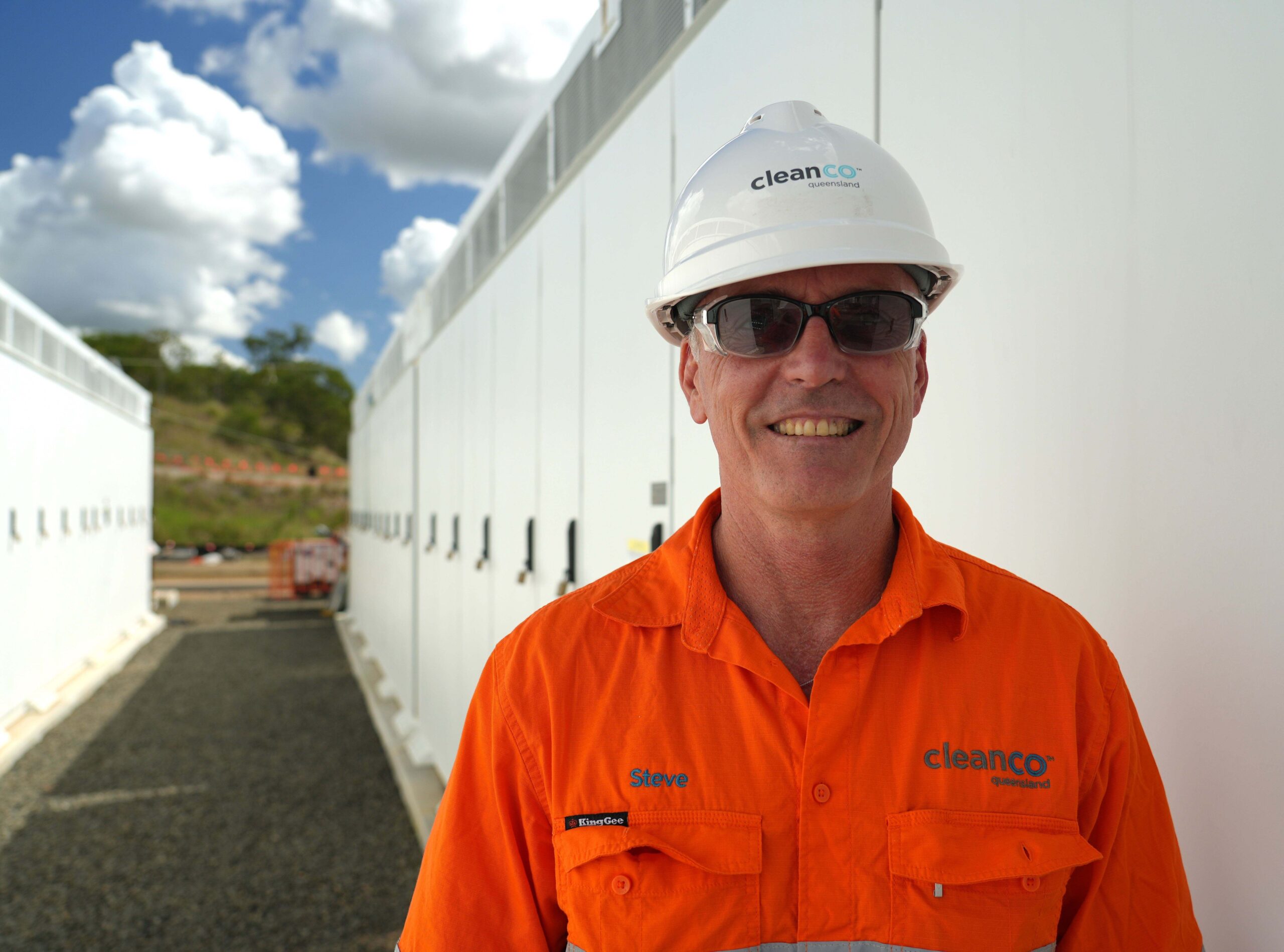 Swanbank Battery Superintendent Steve Hogg stands with the battery site under construction in the background