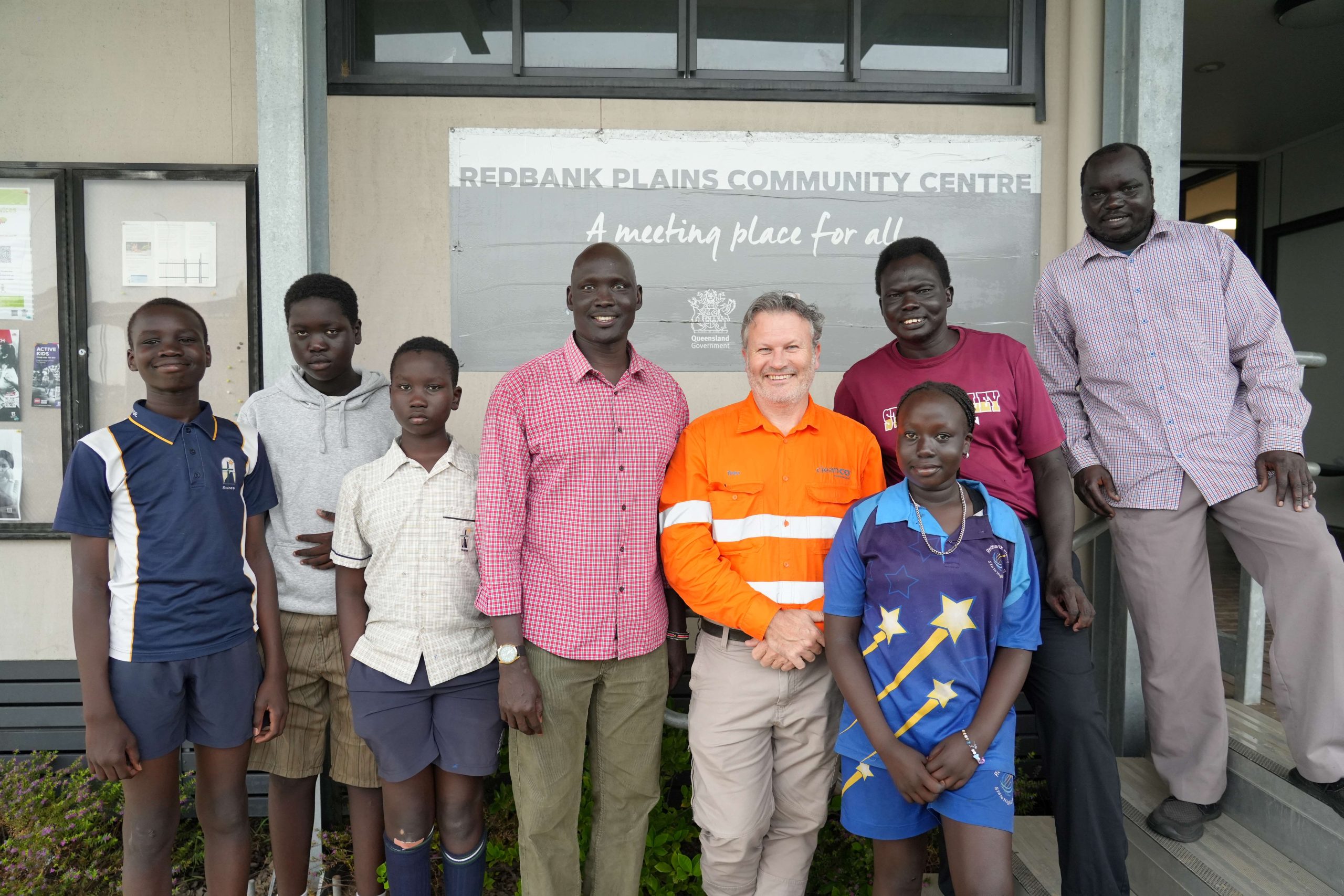 A photo of young school students standing in front of the Redbank Plains Community Centre. Also with them are members of SALBAGOSS (Sudanese Australian Lost Boys and Girls of South Sudan) and CleanCo's Swanbank Site Manager, Trevor Turner. CleanCo was making a donation from our Community Futures Fund to support the club.